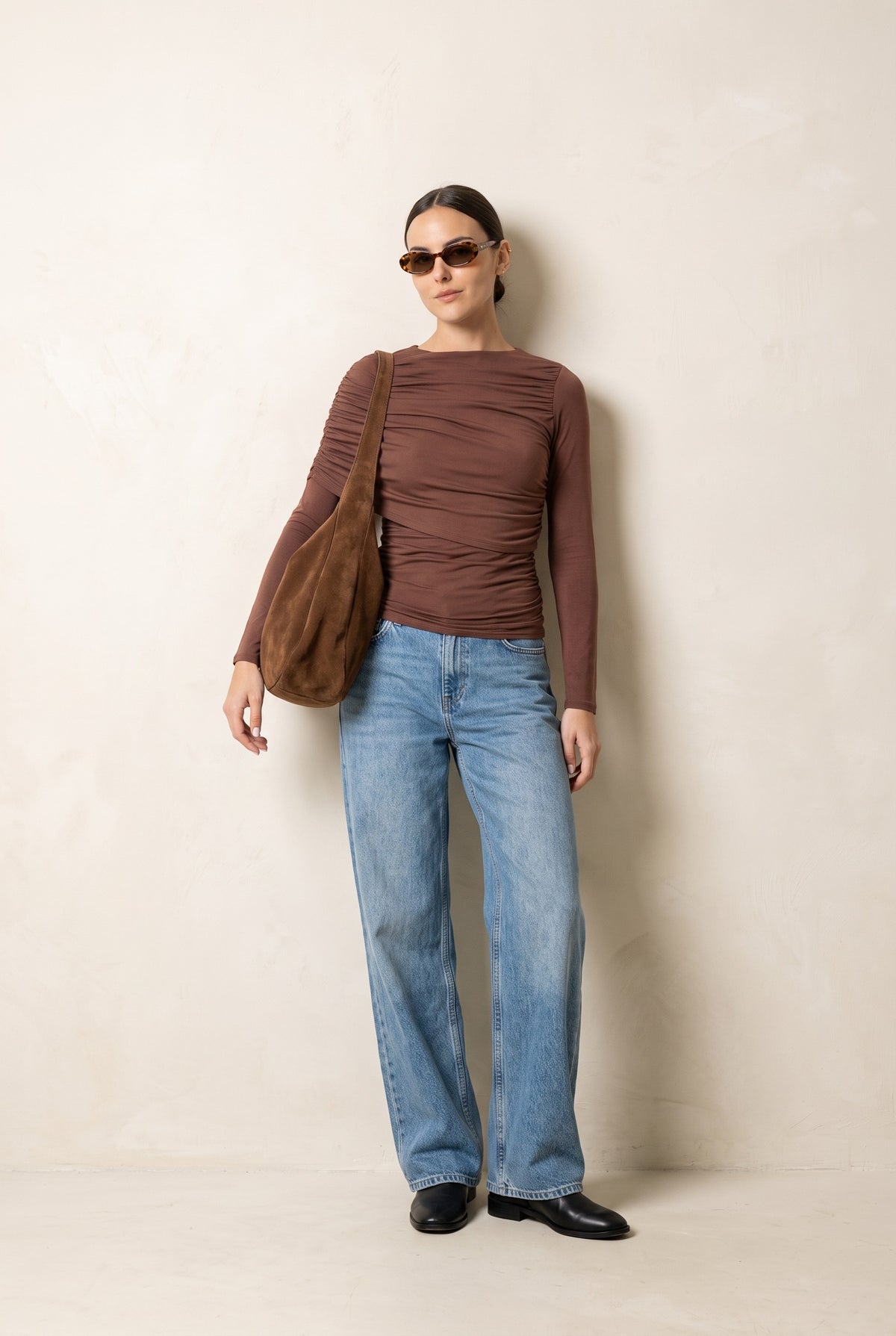Brown asymmetric cape top — styled with wide-leg denim