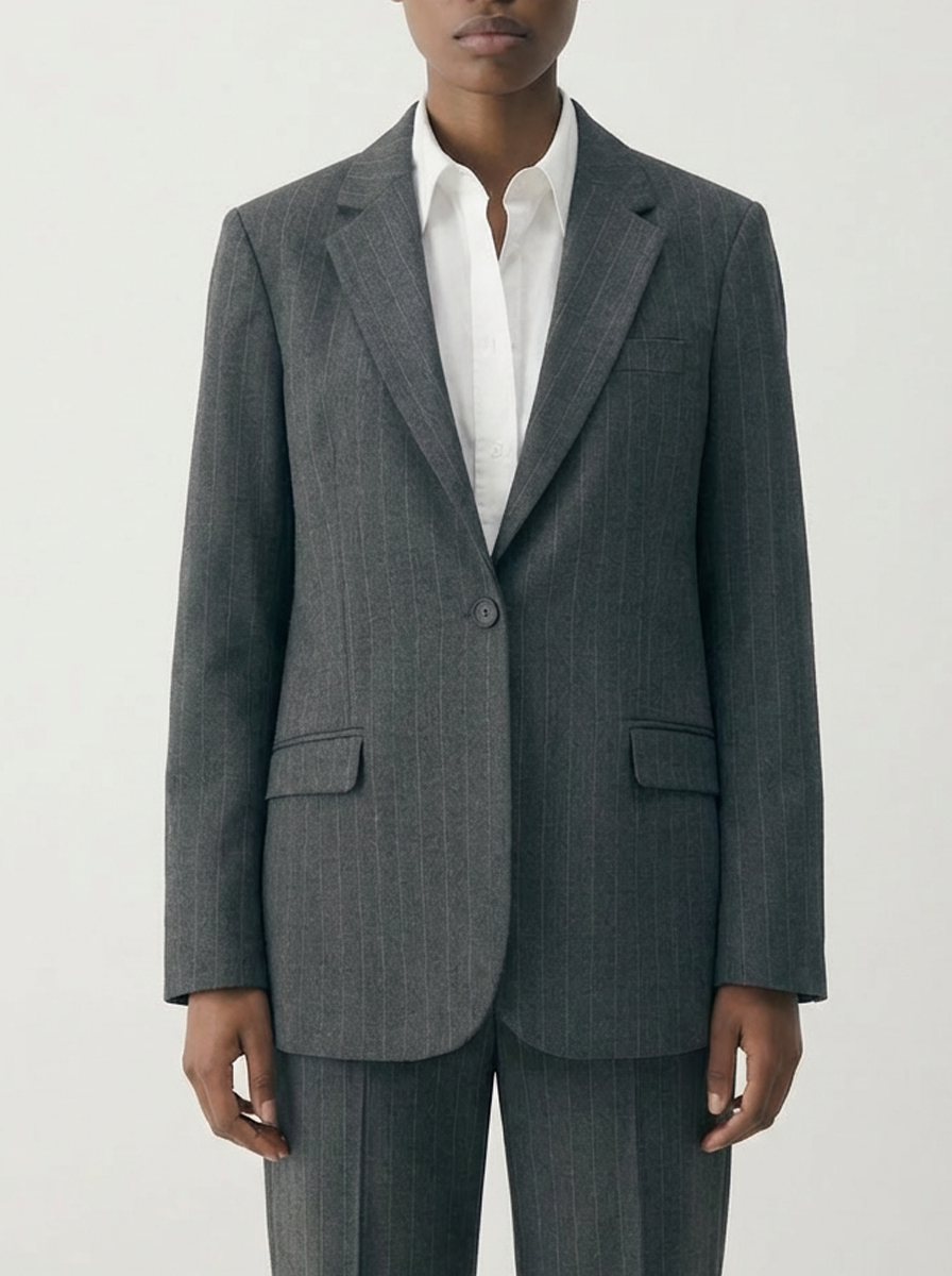 Gray suit jacket worn by a person on a white background